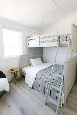a bedroom with two bunk beds and a ladder at Relaxing Mission Beach Getaway - 300ft to sand in San Diego
