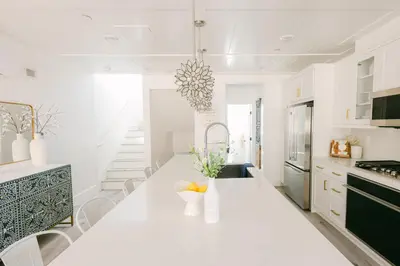 a white kitchen with a table and chairs at Relaxing Mission Beach Getaway - 300ft to sand in San Diego