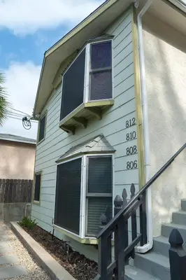 a white house with a window and a balcony at Charming Urban Escape Near Balboa Park & Airport in San Diego