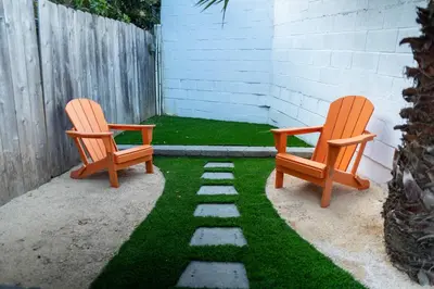 two chairs sitting on a patio with grass at Charming Urban Escape Near Balboa Park & Airport in San Diego