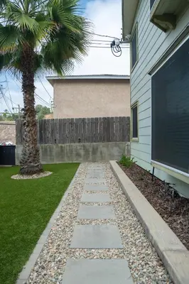a walkway in front of a house with a palm tree at Charming Urban Escape Near Balboa Park & Airport in San Diego