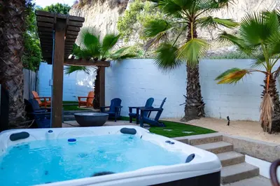 a hot tub in a yard with palm trees at Charming Urban Escape Near Balboa Park & Airport in San Diego