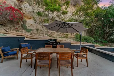 a wooden table with chairs and an umbrella at Charming Urban Escape Near Balboa Park & Airport in San Diego