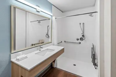 a bathroom with a sink and a mirror at WoodSpring Suites Santee - San Diego Northeast in Santee