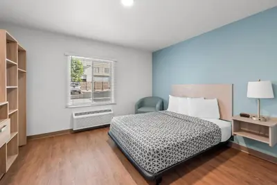 a bedroom with a bed and a window at WoodSpring Suites Santee - San Diego Northeast in Santee