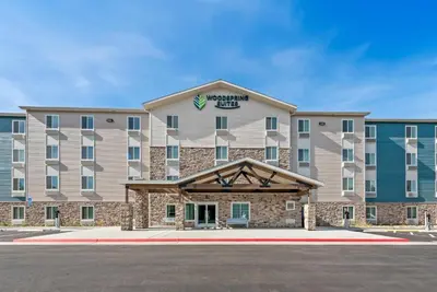 an image of a hotel with a building at WoodSpring Suites Santee - San Diego Northeast in Santee