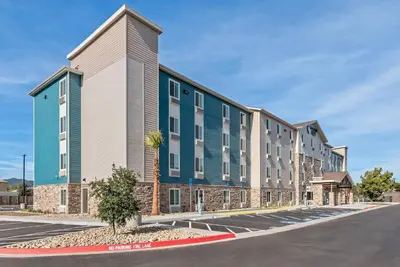 a rendering of the exterior of a building at WoodSpring Suites Santee - San Diego Northeast in Santee