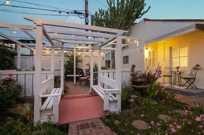 a patio with a white pergola next to a house at Bird Rock, La Jolla Whitewater with AC in La Jolla