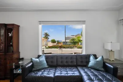 a living room with a couch and a large window at Bird Rock, La Jolla Whitewater with AC in La Jolla