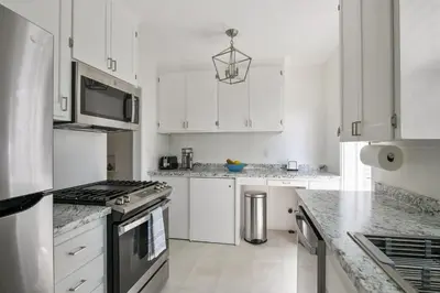 a kitchen with white cabinets and a stove top oven at Bird Rock, La Jolla Whitewater with AC in La Jolla