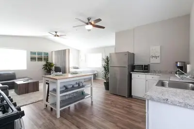 a kitchen with a refrigerator and a counter top at Modern Loft Retreat - North Park San Diego in San Diego