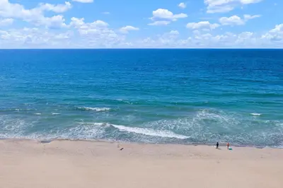 two people standing on a beach near the ocean at Top of the Wave - DMST31 in Solana Beach