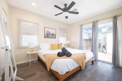 a bedroom with a bed and a ceiling fan at Centra Spacious Villa in San Diego