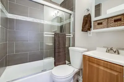 a bathroom with a toilet and a sink and a shower at Mission Bay Getaway - Walk to the Water in San Diego