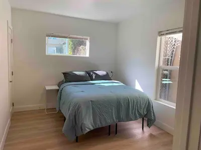 a bedroom with a bed in a white room at 2 Bedroom Modern North Park Gem in San Diego