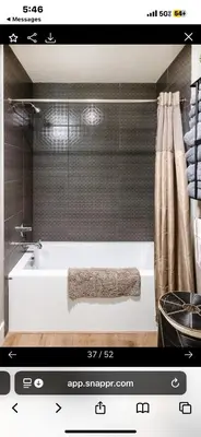 a bathroom with a bath tub with a shower at Janna hospitality in San Diego