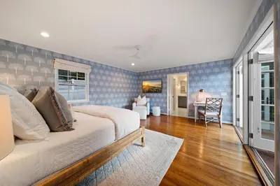 a bedroom with a bed and a table in a room at Coastal Elegance by the Shore in San Diego