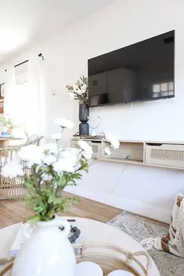 a living room with a vase with flowers on a table at Work-From-Beach Dream Ocean Views Hot tub, BBQ in Oceanside