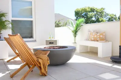 a tub and a chair on a patio at Work-From-Beach Dream Ocean Views Hot tub, BBQ in Oceanside
