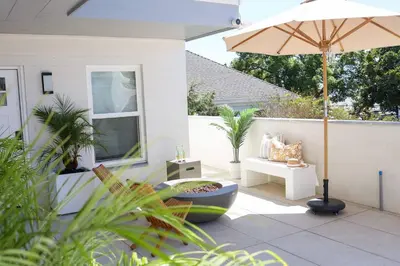 a patio with an umbrella and a bench and a table at Work-From-Beach Dream Ocean Views Hot tub, BBQ in Oceanside