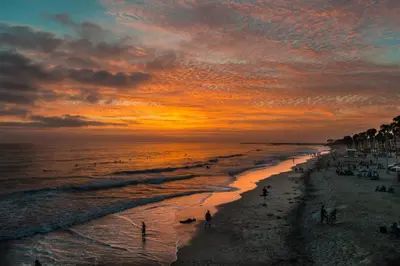 a group of people on the beach at sunset at Work-From-Beach Dream Ocean Views Hot tub, BBQ in Oceanside