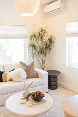 a living room with a white couch and a table at The Swell Oceanview Designer Stay Hot Tub in Oceanside
