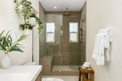 a bathroom with a shower with a glass door at The Swell Oceanview Designer Stay Hot Tub in Oceanside