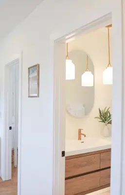 a bathroom with a sink and a mirror at The Swell Oceanview Designer Stay Hot Tub in Oceanside