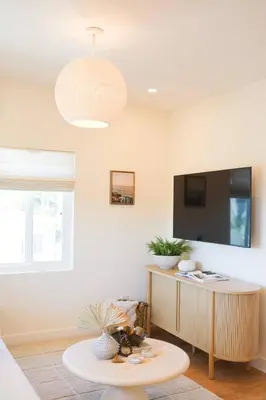 a living room with a table and a tv at The Swell Oceanview Designer Stay Hot Tub in Oceanside
