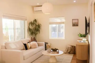 a living room with a couch and a table at The Swell Oceanview Designer Stay Hot Tub in Oceanside