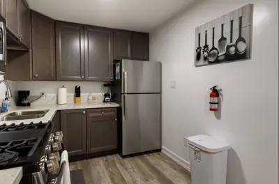 a kitchen with wooden cabinets and a stainless steel refrigerator at 2-bedroom apartment Central San Diego! in San Diego