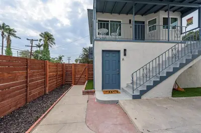 a house with a blue door and a fence at 2-bedroom apartment Central San Diego! in San Diego