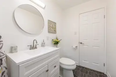 a white bathroom with a sink and a mirror at 2-bedroom apartment Central San Diego! in San Diego