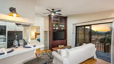 a living room with a white couch and a television at Scenic Deck w Sunset Views Near Temecula Wineries Estrada Ranch by AvantStay in Fallbrook