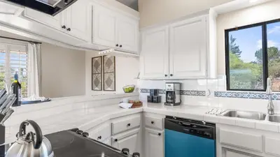 a kitchen with white cabinets and a blue dishwasher at Scenic Deck w Sunset Views Near Temecula Wineries Estrada Ranch by AvantStay in Fallbrook