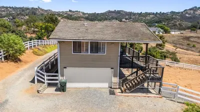 a small house with a porch and a staircase at Scenic Deck w Sunset Views Near Temecula Wineries Estrada Ranch by AvantStay in Fallbrook