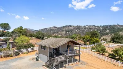 a house on the side of a dirt road at Scenic Deck w Sunset Views Near Temecula Wineries Estrada Ranch by AvantStay in Fallbrook