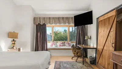 a bedroom with a bed and a desk and a window at Resort-Style Estate w Pool Game Room Tennis Court Near Wineries The Tennis Ranch by AvantStay in Escondido