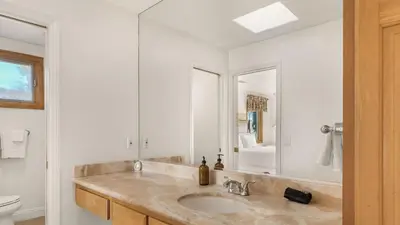 a bathroom with a sink and a mirror at Resort-Style Estate w Pool Game Room Tennis Court Near Wineries The Tennis Ranch by AvantStay in Escondido