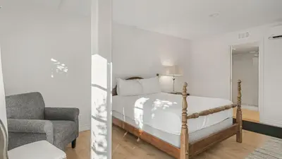 a bedroom with a bed and a chair at Resort-Style Estate w Pool Game Room Tennis Court Near Wineries The Tennis Ranch by AvantStay in Escondido