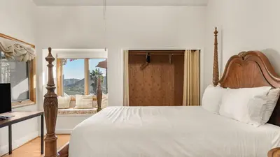 a bedroom with a bed and a desk and a window at Resort-Style Estate w Pool Game Room Tennis Court Near Wineries The Tennis Ranch by AvantStay in Escondido