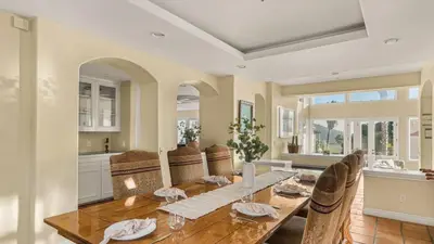 a dining room with a wooden table and chairs at Two Estates w Pools Hot Tubs Game Rooms Valley Views Tennis Court Near Beaches Wineries in Escondido