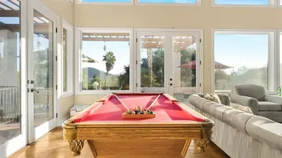 a living room with a pool table in the middle at Two Estates w Pools Hot Tubs Game Rooms Valley Views Tennis Court Near Beaches Wineries in Escondido
