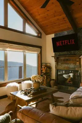 a living room with a table and a fireplace at Wild Moon Ranch with Pickleball, Cedar Tub, Views in Julian