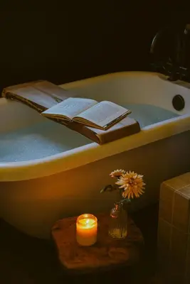 a bathroom with a bath tub with a candle and a book at Wild Moon Ranch with Pickleball, Cedar Tub, Views in Julian