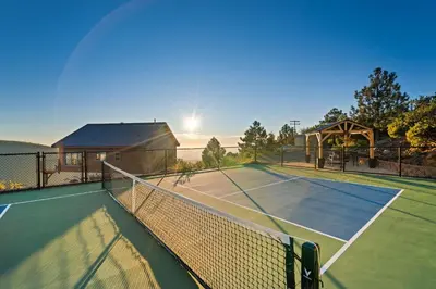 a tennis court with a net in front of a house at Wild Moon Ranch with Pickleball, Cedar Tub, Views in Julian