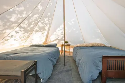 two beds in a room with a tent at Cozy Bell Tent in Palomar Mountains in Pauma Valley