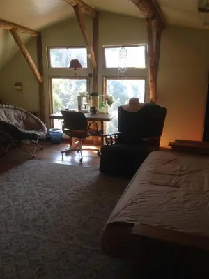 a bedroom with a bed and a table and two chairs at Harrison Serenity Ranch - Groups over 50 in Palomar Mountain