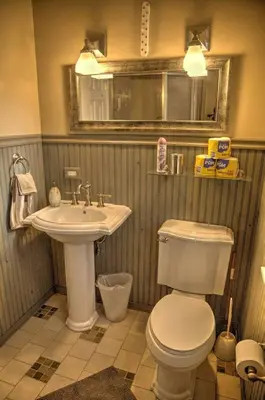 a bathroom with a white toilet and a sink at Harrison Serenity Ranch - Groups over 50 in Palomar Mountain