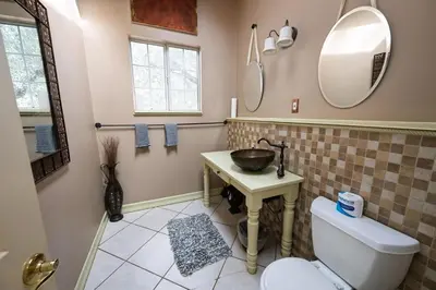 a bathroom with a toilet and a sink and mirror at Cozy Rustic Mountain Home with Breathtaking views in Palomar Mountain